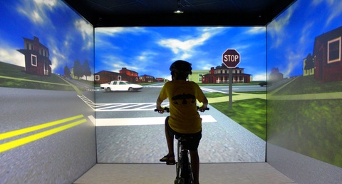 Child riding a bike in a simulator 